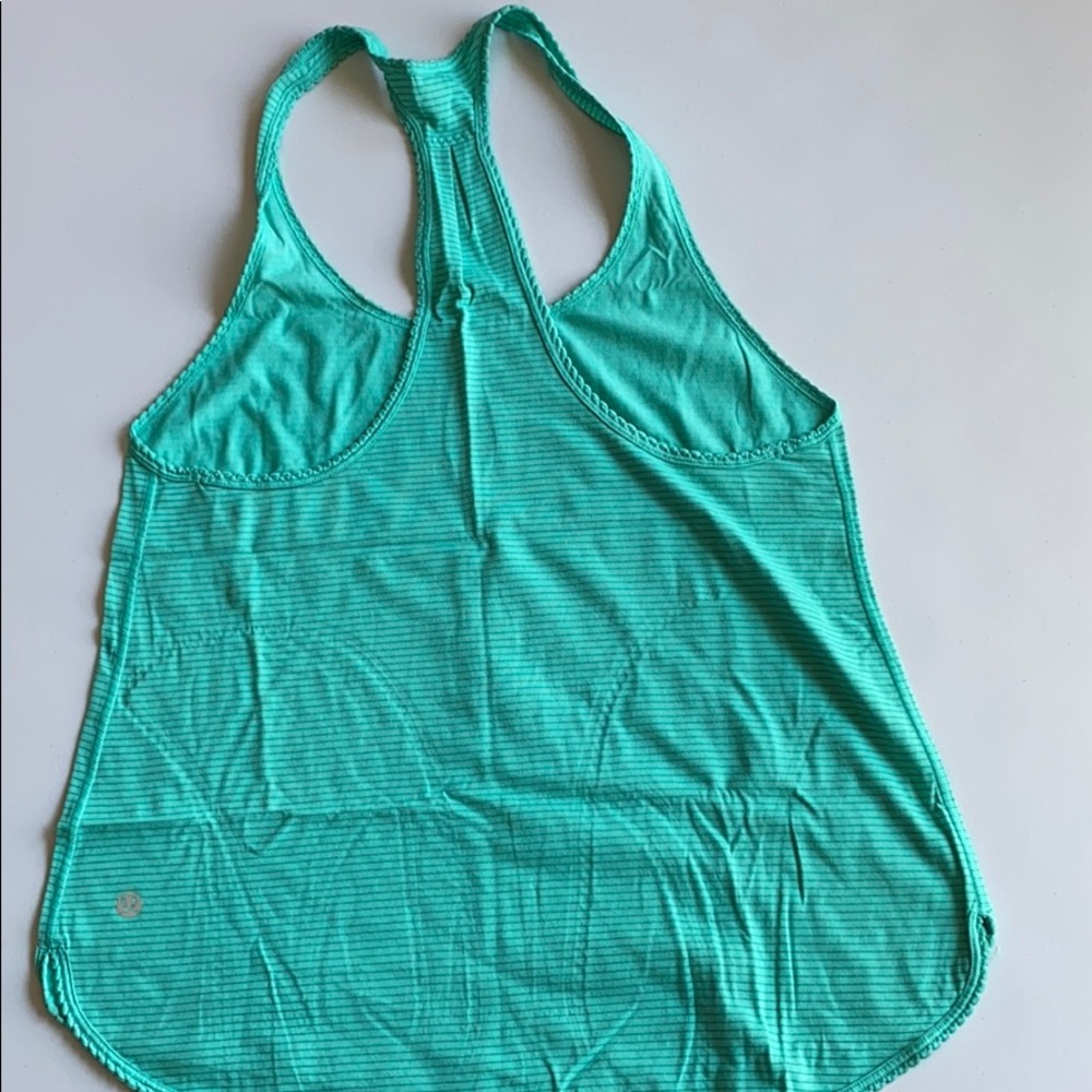 Lululemon workout tank in green color.